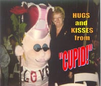 a person standing beside a cupid mascot