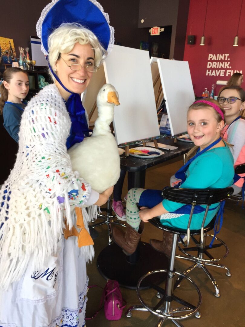 a woman dressed as mother goose with girls